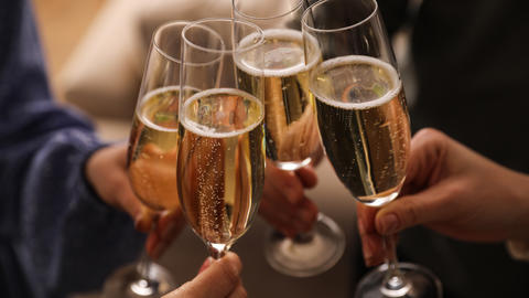 People clinking champagne glasses