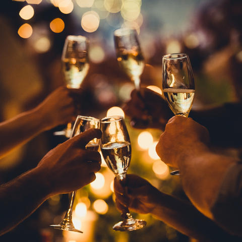 People clinking champagne glasses